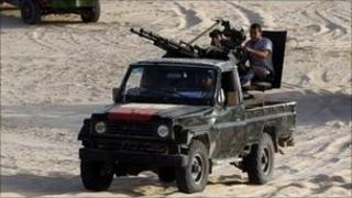 Anti-Gaddafi fighters patrol near the town of al Washka some 140km (87 miles) west of Sirte.
