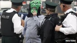 A defendant wears a mask to conceal his identity as he arrives at court in Belfast ahead of the trial