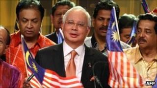 Malaysian Prime Minister Najib Razak (c) during the televised statement