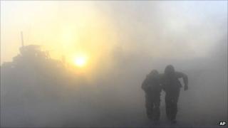 Soldiers walking after a roadside bomb exploded in the Helmand Province of southern Afghanistan
