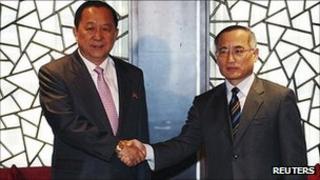 South Korea's top nuclear envoy Wi Sung-lac (R) and his North Korean counterpart Ri Yong-ho pose before their meeting in Beijing