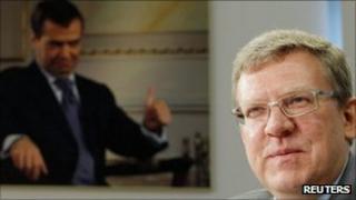 Russian Finance Minister Alexei Kudrin with photo of President Dmitry Medvedev in background - 13 September 2011