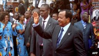 Cameroon's President Paul Biya waves to supporters during the opening of his party conference, in Yaounde