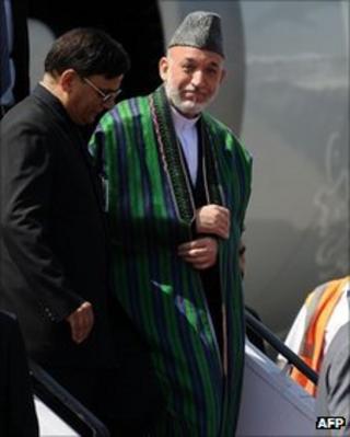 Президент Афганистана Хамид Карзай (2L) прибывает в Дели 4 октября 2011 года.