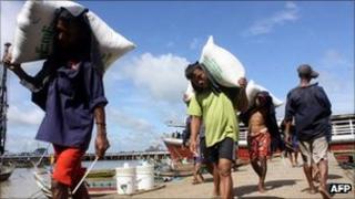 File image of labourers carrying sacks in Rangoon on 3 September 2011