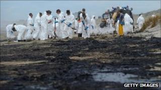 Soldiers continue clean-up operations on the Bay of Plenty coastline on New Zealand's North Island on Thursday, after more oil from the stricken vessel Rena washed up