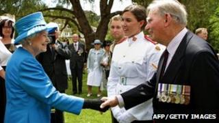 Britain"s Queen Elizabeth II (L) meets with Arthur "Bushy" Pembroke (R) and his granddaughter, Staff Cadet Harriet Pembroke (2nd R), after presiding over the "Presentation of the Colours" to the Royal Military College, Duntroon in Canberra