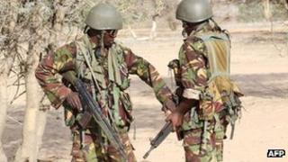 Kenyan soldiers talk as they prepare to advance near Liboi in Somalia, on 19 October 2011