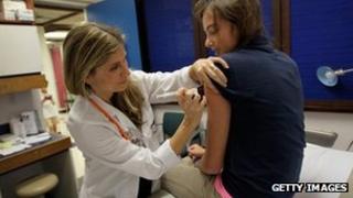 Judith L. Schaechter, MD gives an HPV vaccination to a 13-year-old girl on 21 September 2011