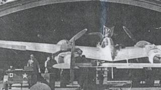 A Lockheed P38 Lightning in a blister hanger at Stoneycross