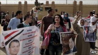 Egyptians supporters of former President Hosni Mubarak gather outside the courts set up at the Police Academy