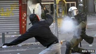 Policeman fires tear gas at Athens protester, 19 Oct 11