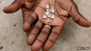 An illegal Zimbabwean diamond dealer holding gems from Zimbabwe - (Photographed in Manica in Mozambique, near Zimbabwe's border, September 2010)