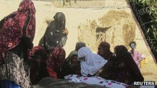 Afghan women mourn civilians killed by a suicide attack in Baghlan province on 6 November 2011