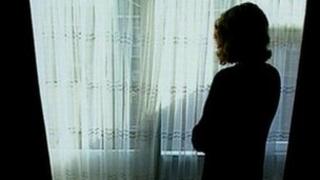 Generic woman standing at a window