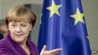 German Chancellor Angela Merkel passes an EU flag in Berlin, 2 November
