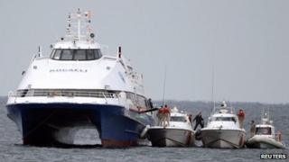 Coastguard boats rescue passengers from the Kartepe ferry