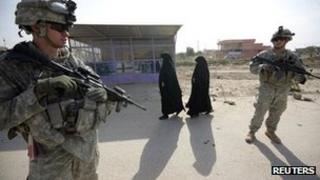 US soldiers stand guard during the distribution of medical aid and supplies to the Imam Ali Hospital in Jibella, south of Baghdad, on 12 November 2011