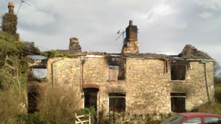 The fire-damaged farmhouse