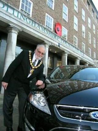 Nottinghamshire County Council chairman Keith Walker leans on a civic car