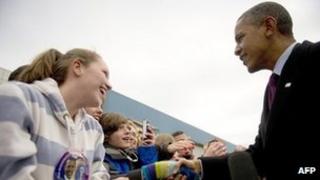 US President Barack Obama (R) at airport in Manchester, New Hampshire, on 22 November 2011