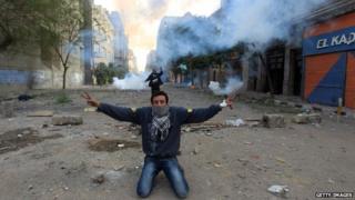 Protester in Egypt kneels on ground