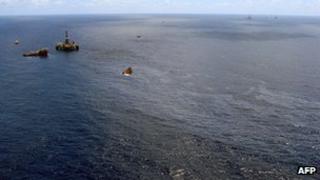 Supply boats cleaning an oil spill around a Chevron platform operating in the Frade oil field offshore of Rio de Janeiro, Brazil