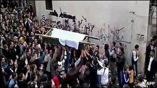 An image grab taken from a video uploaded on YouTube shows Syrian mourners carrying the coffin of a victim killed in recent violence in Tal Kalakh in the Homs governorate