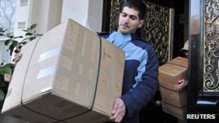 Delivery men take boxes from the embassy