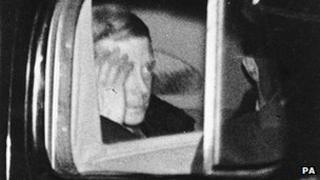 The Duke of Windsor hides his face leaving Windsor Castle