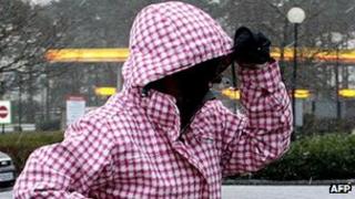 A woman takes cover during last week's storm in Scotland