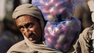 Man with bags of tomatoes