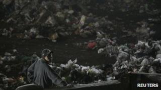 A man stands near waste at the Bordo Poniente landfill site outside Mexico City