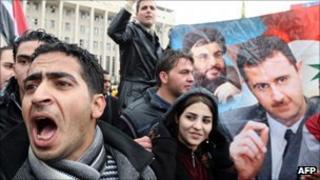 Assad supporters in Damascus shout slogans