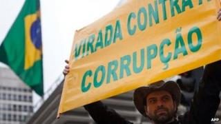 A demonstrator holds a sign during the demonstration against corruption in Sao Paulo, Brazil on 15 November, 2011