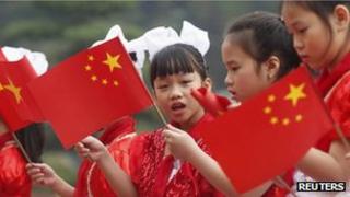 Vietnamese children waving the Chinese flag