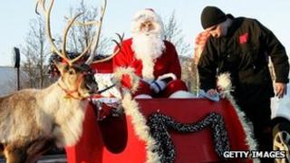 Santa in his sleigh with a reindeer