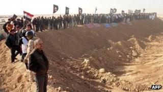 Iraqi demonstrators protest outside Camp Ashraf, home to exiled Iranian opposition members, in the western Diyala province calling for the camp to be closed and for its residents to be deported on December 9, 2011.