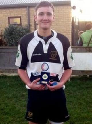 Toby Hearne - wearing rugby kit and holding a trophy