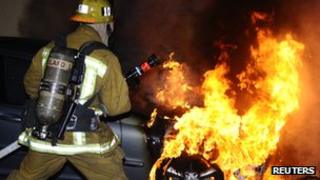 LA firefighter tackles arson attack on a car in North Hollywood, California, on 31 December 2011