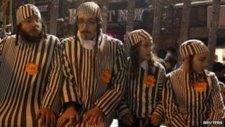 Ultra-Orthodox Jews wear striped black-and-white uniforms associated with Nazi concentration camps at a protest in Jerusalem (31 December 2011)