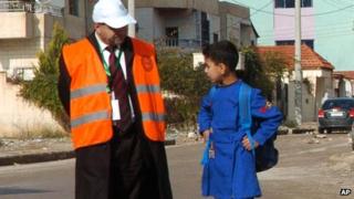 An Arab League monitor speaks with a Syrian pupil in Deraa, on 3 January 2012