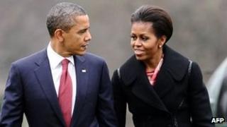 President Barack Obama and First Lady Michelle Obama walk to the White House on 14 December 2011