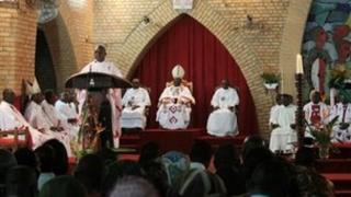 Metropolitan Archbishop Cardinal Mosengo (C-back) listens to Bishop Satendi (L) as he reads a statement, at Notre Dame Cathedral in Kinshasa on January 12 2012