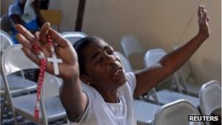 A woman prays during a church service to mark the second anniversary of the 2010 earthquake in Port-au-Prince January 12, 2012