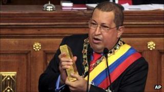 Venezuelan President Hugo Chavez brandishes a gold bar as he addresses the National Assembly in Caracas