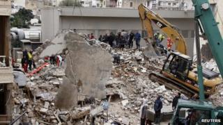 Workers remove rubble at the site of a collapsed building in Beirut, Lebanon, on 16 January 2012