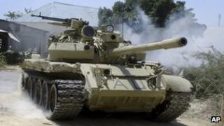 An African Union (AU) peacekeeper tank moves between positions following clashes with al-Shabab militants in Mogadishu, Somalia, Friday, Jan. 20, 2012.