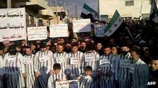 Grab of video purportedly showing opposition activists dress as prisoners in protest in the city of Idlib at the detention of thousands of people during the Syrian uprising (20 January 2012)