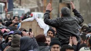 The coffin of Maher Hamad, 14, is carried during his funeral procession in the northern Lebanese village of Arida on January 22